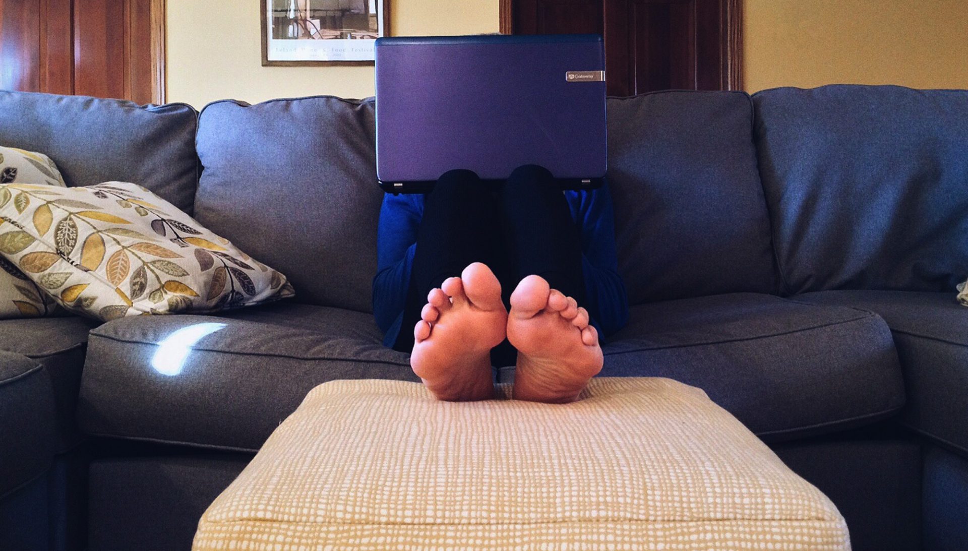 A person working from home on their couch